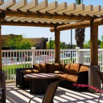 Poolside gazebo with comfortable L shaped outdoor cushioned couch and coffee table.