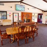 The clubhouse has an organ for playing and announcements on a corkboard of community events. A wood table with chairs is available. A big screen TV is mounted above the fireplace