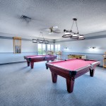 Game room with two pool tables and foosball.