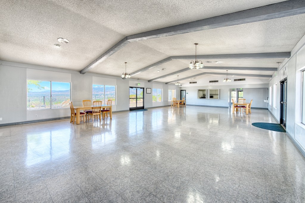 Large clubhouse with tall vaulted ceiling and wide open space to host events. Beautiful view of skyline to downtown Reno and mountains.