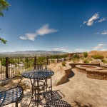 A bistro table and chairs outside offer a wonderful view of the mountains and downtown Reno. Stone firepit with seating around it.