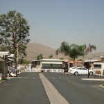 Bel Air Estates, an active 55 plus community in Menifee, California has wide, clean paved streets. Rolling hills in background.