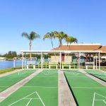Four shuffleboard courts with covered seating. Sits next to lake.