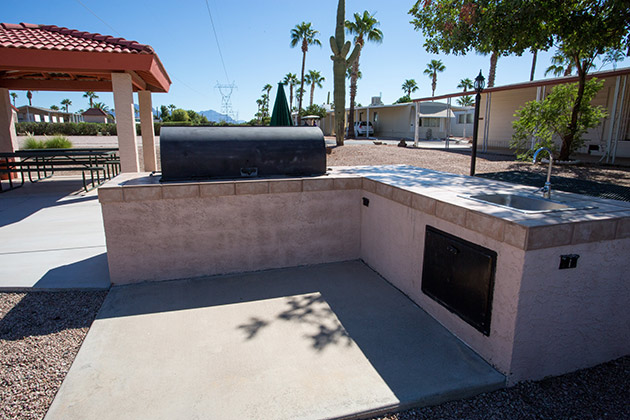 Large built in barbecue area with patio area and sink