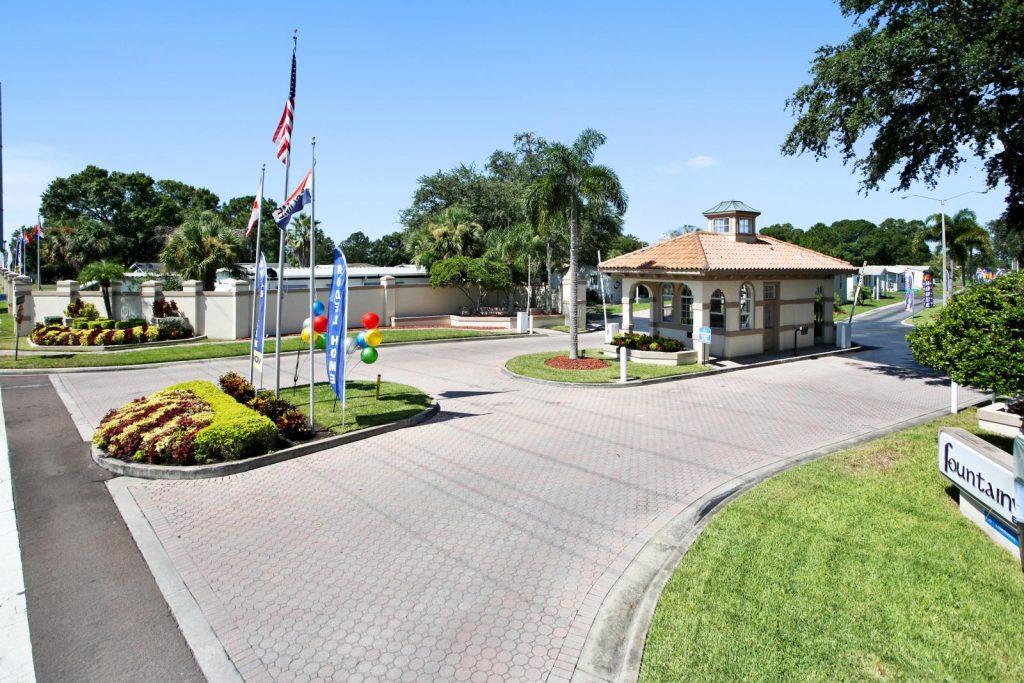 Very clean gated entrance to Fountainview Estates. Security booth for in and out of community. Well kept landscape with American flag flying on flag pole. Lots of plush greenery.