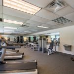 Fitness center in the community equipped with treadmills, weight machines and water fountain.