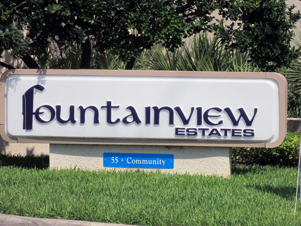 Sign labeling Fountainview Estates, a 55 + community, at the entrance.