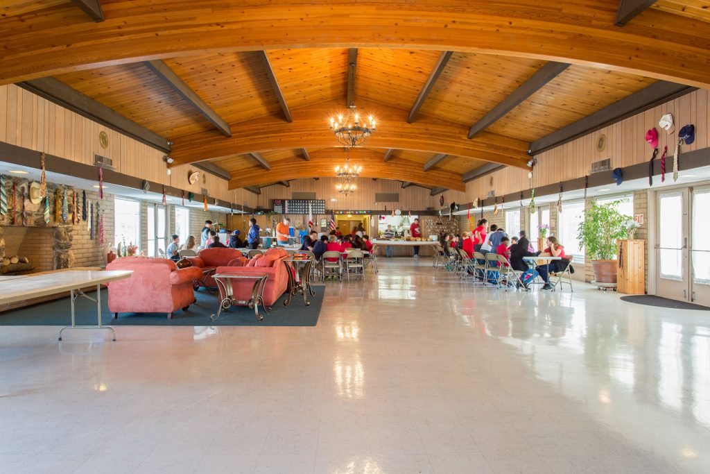 Open concept community center with high vaulted ceilings provides a space for residents to enjoy activities with one another.