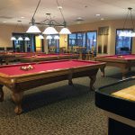 Montesa at Gold Canyon, an upscale 55 plus community, with a billiards room. 4 pool tables, dart board. TV mounted to the ceiling and high chairs and tables to use