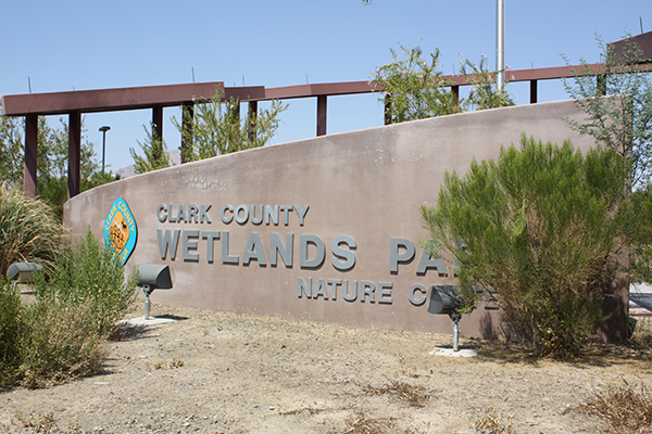 Tropicana Palms, an active 55 plus manufactured home community, is next to the Clark County Wetlands Park and Nature Center. Sign set in desert landscape.