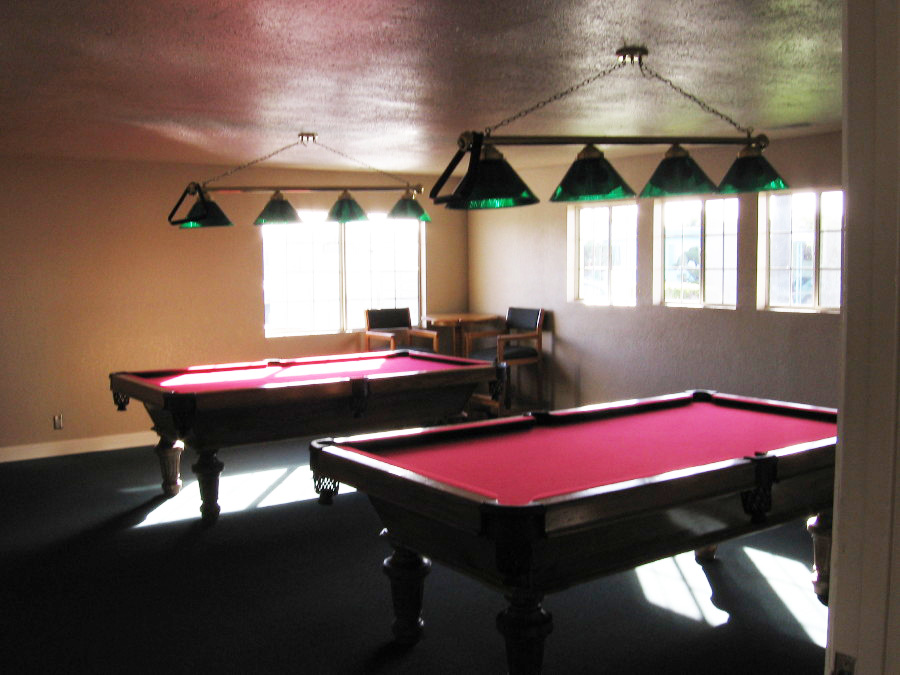 Billiards and game room equipped with two pool tables for residents use.
