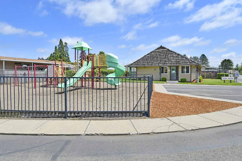Community playground enclosed by gates for residents to enjoy. Adjacent to the youth center.