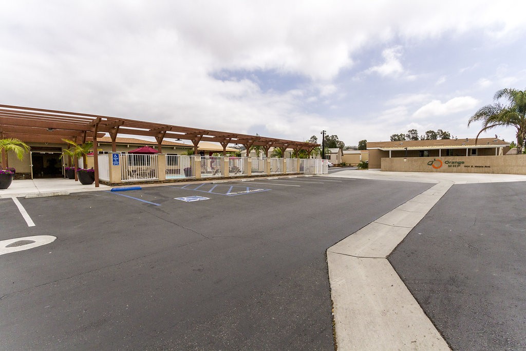 Large, open parking lot at the entrance of the community center. Easy access to the community center, the outdoor pool, and entrance into the community.
