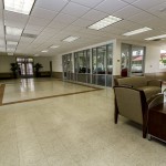 Large, open community center connected to the leasing office. Light linoleum flooring throughout and space for activities, hosting of parties, and much more.