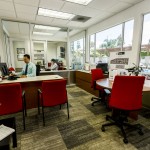 Community leasing office equipped with two different, adjacent offices. Welcoming space with a view of the community pool. Vibrant red chairs provide seating for current and potential residents.
