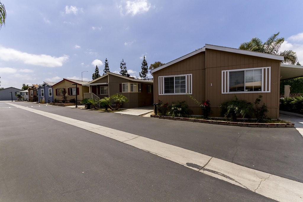 Street view of Orange Mobile Home Park, a family friendly community, with wide, clean streets, and beautiful manufactured homes.
