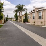 Wide, clean streets lined with well-maintained manufactured homes and landscape. Beautiful neutral colored homes and ample greenery give color to the community.