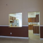 Community room has a kitchen with white fridge, microwave, sink oven