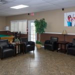 Tiled flooring in the billiards room with comfortable leather seating.