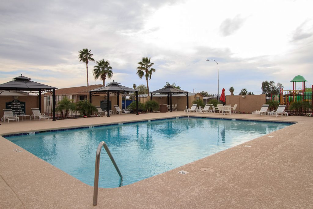 Sierra Estates, an all age community in Mesa Arizona has a community pool with cabanas and lounge chairs around the pool