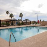 Sierra Estates, an all age community in Mesa Arizona has a community pool with cabanas and lounge chairs around the pool