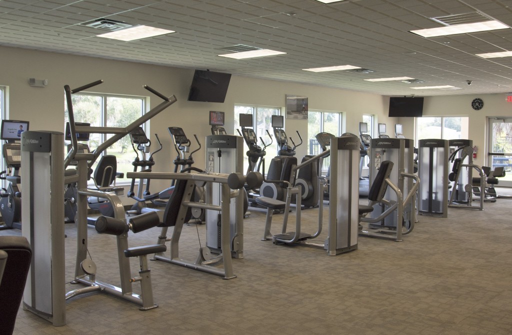 Fully equipped fitness center with weight machines and also TVs for enjoying while working out.
