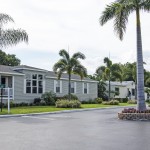 Beautiful manufactured homes are nicely landscaped with green grass, palm trees and small trimmed shrubs. Clean paved streets.