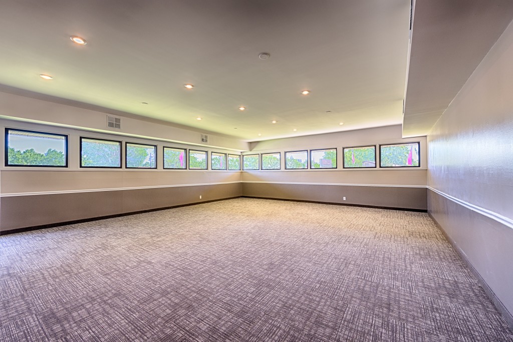 New carpeted meeting room with windows on 2 walls. Recessed lighting.