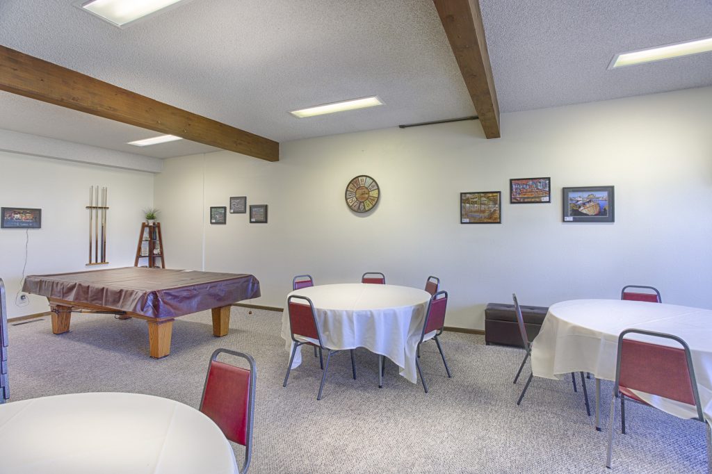 Community center equipped with billiard tables, multiple seating for community activities.