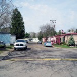 This manufactured home community has wide clean paved streets. Cars can park on the street outside their home.