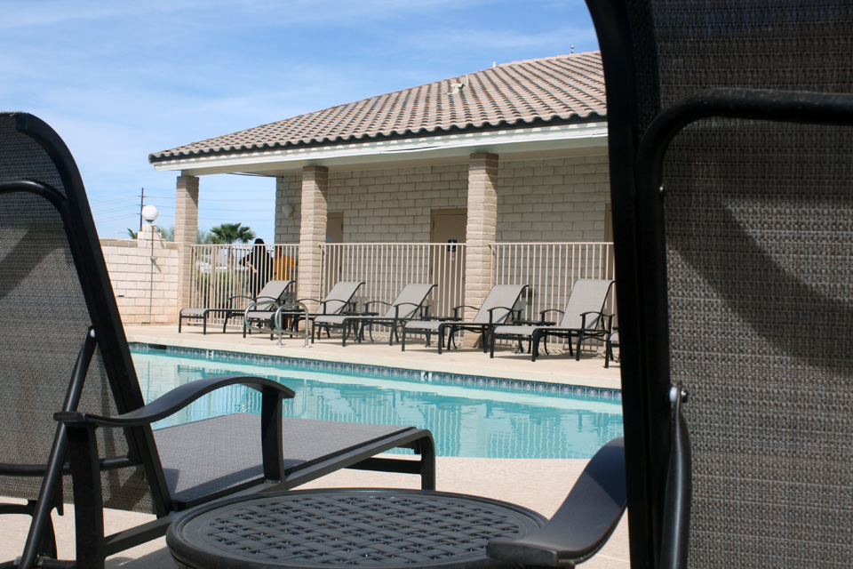 Cimarron Trails, a 55 plus manufactured home community in San Tan Valley Arizona offers comfortable lounge chairs around the pool.