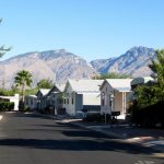 Clean, paved streets through the neighborhood with beautiful mountain scenery as the background.