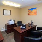 Desk and seating within the leasing office. Small coffee stand for residents and potential buyers.