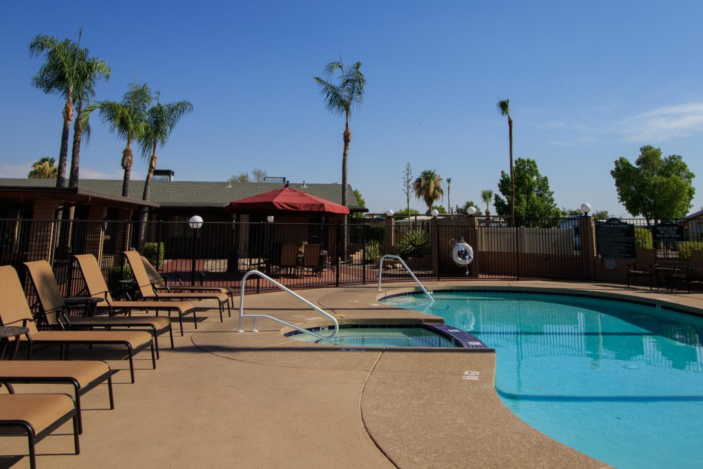 Community pool connected to the spa and surrounded by ample poolside seating.