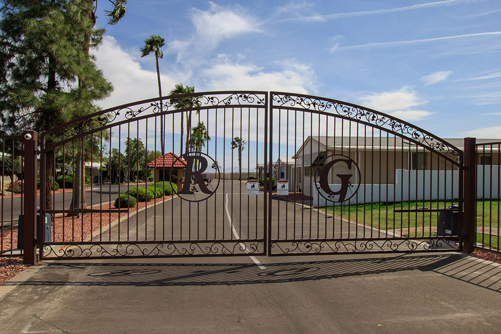 large vehicle gates at community entrance with an R and G welded into the ironwork