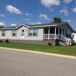 Avalon Estates, an all age manufactured home community offers homes with covered porches and green grass.